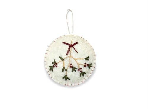 Round pale felt ornament with an embroidered mistletoe sprig and dark red bow