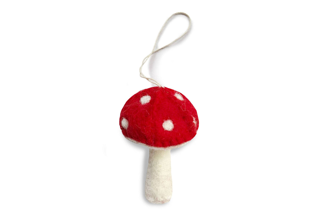 Red felt mushroom ornament with white spots and a pale hanging loop