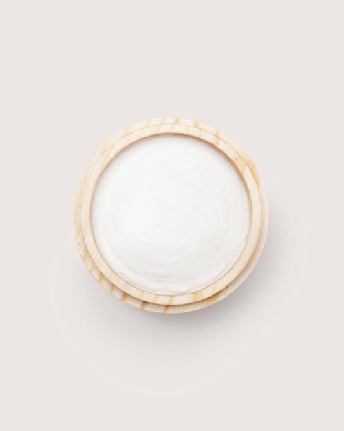 Open wooden jar of white Hetkinen hand balm, viewed from above